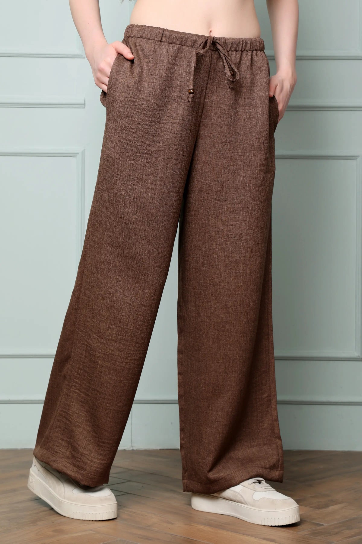Side view of RABRIC chocolate brown linen wide leg trousers for women with relaxed fit