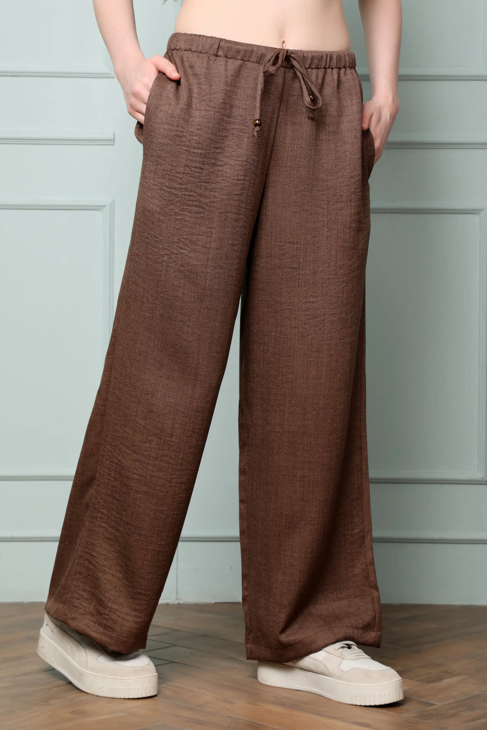 Side view of RABRIC chocolate brown linen wide leg trousers for women with relaxed fit