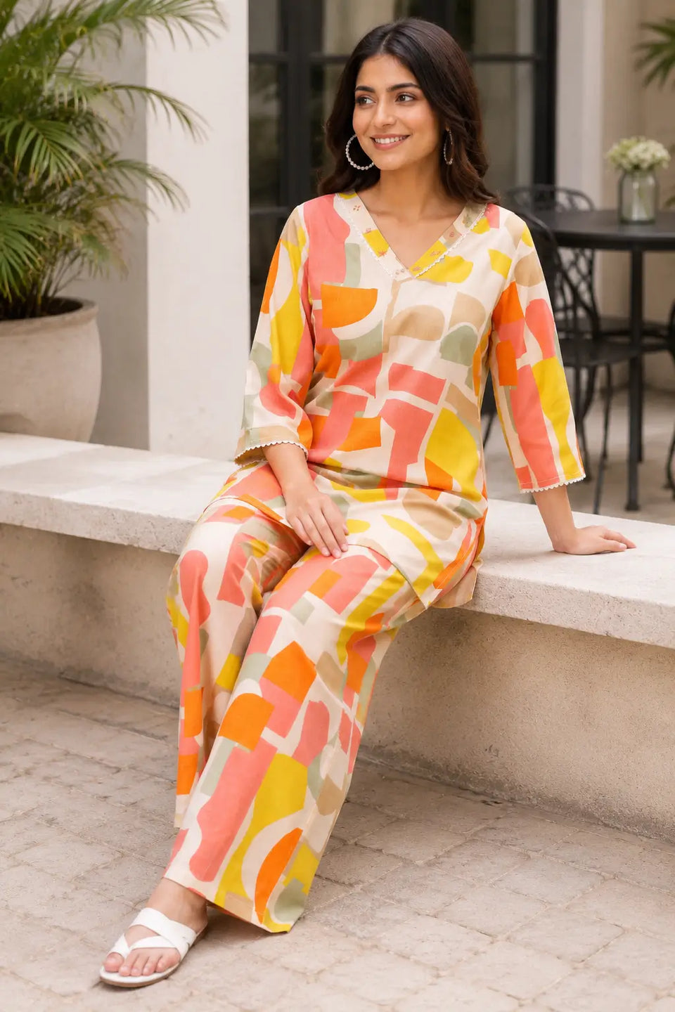 Relaxed lifestyle look featuring Rabric cotton co-ord set in cream beige coral orange yellow and sage green abstract geometric print