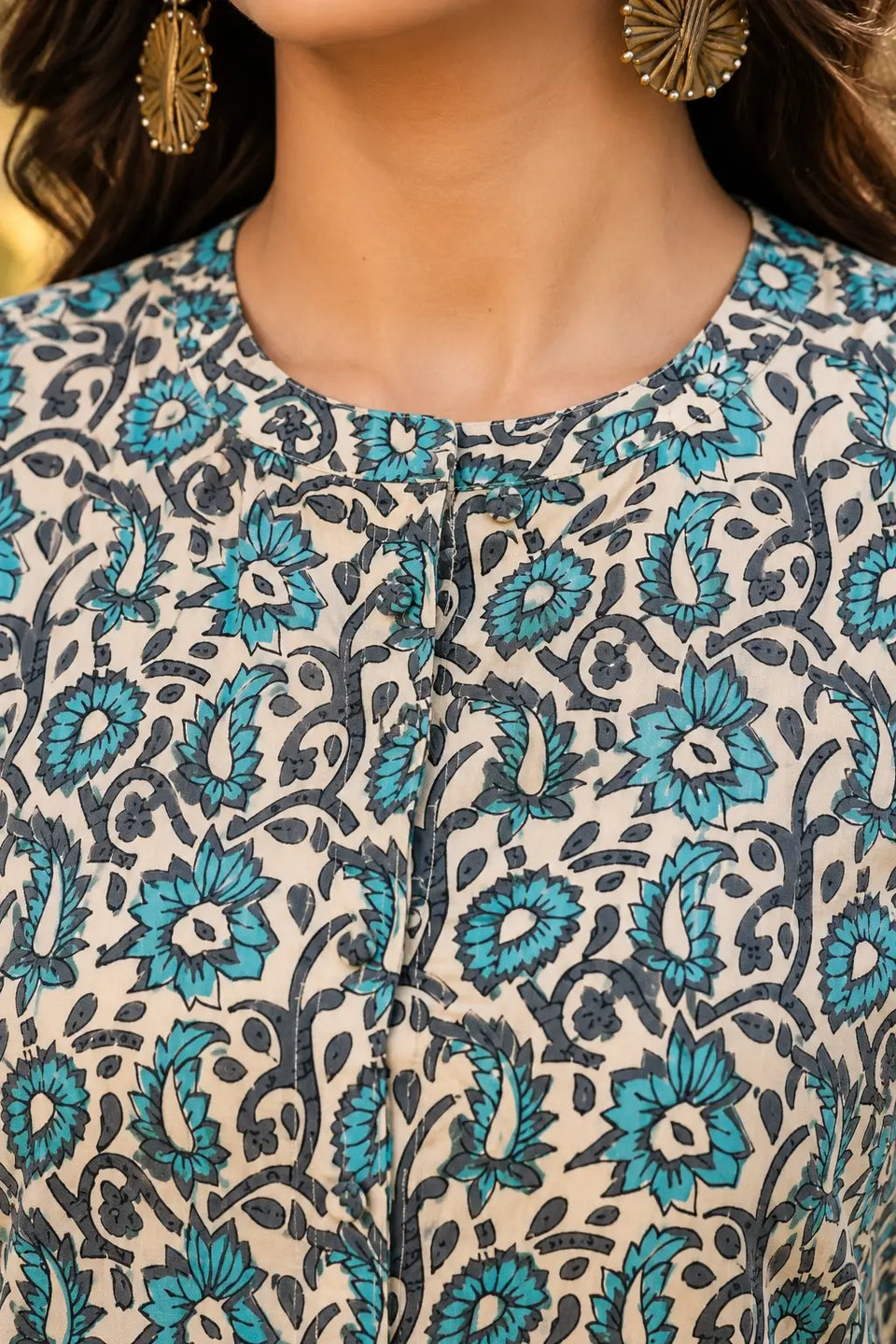 Close up neck design of Rabric floral cotton short top for women with front button openable detail and round neckline