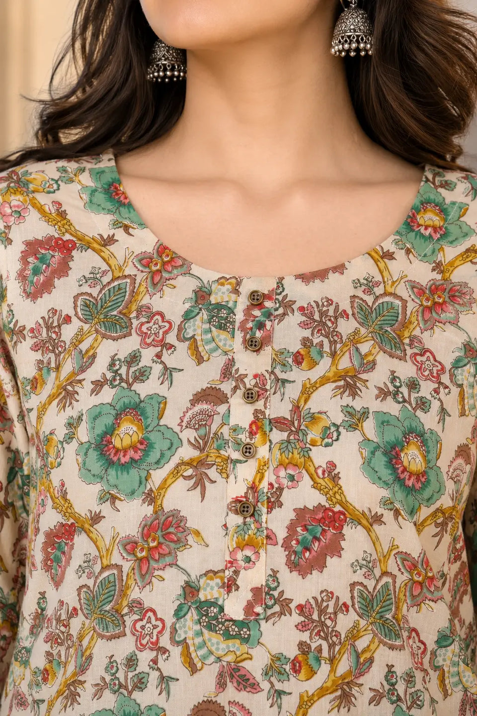 Closeup of round neck design on Rabric floral print cotton kurta for women with button detailing and soft cream fabric