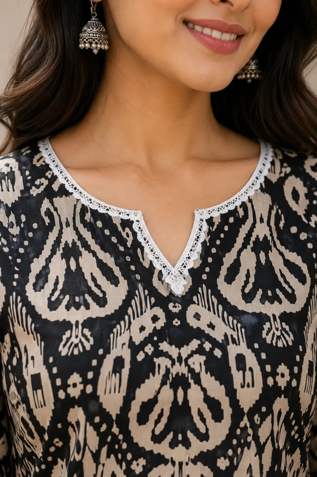 Close up neck design of Rabric cotton short kurti featuring lace trim V neckline and ethnic print pattern