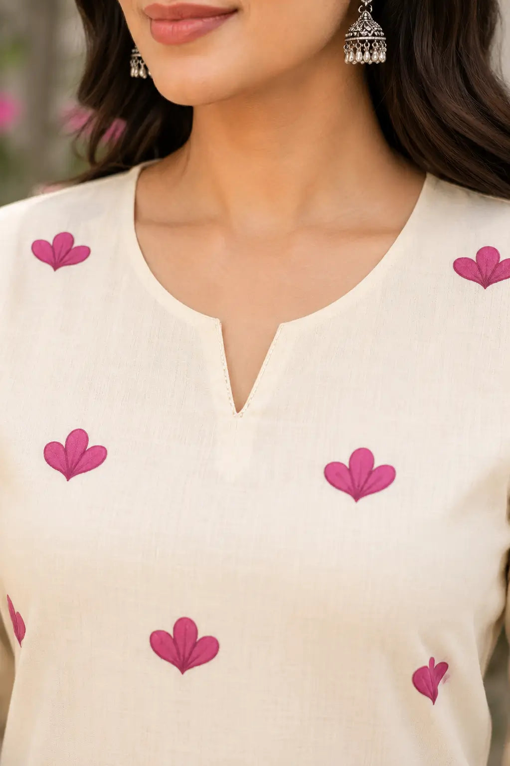 Closeup of stylish neck design on Rabric cream cotton floral print kurti for women