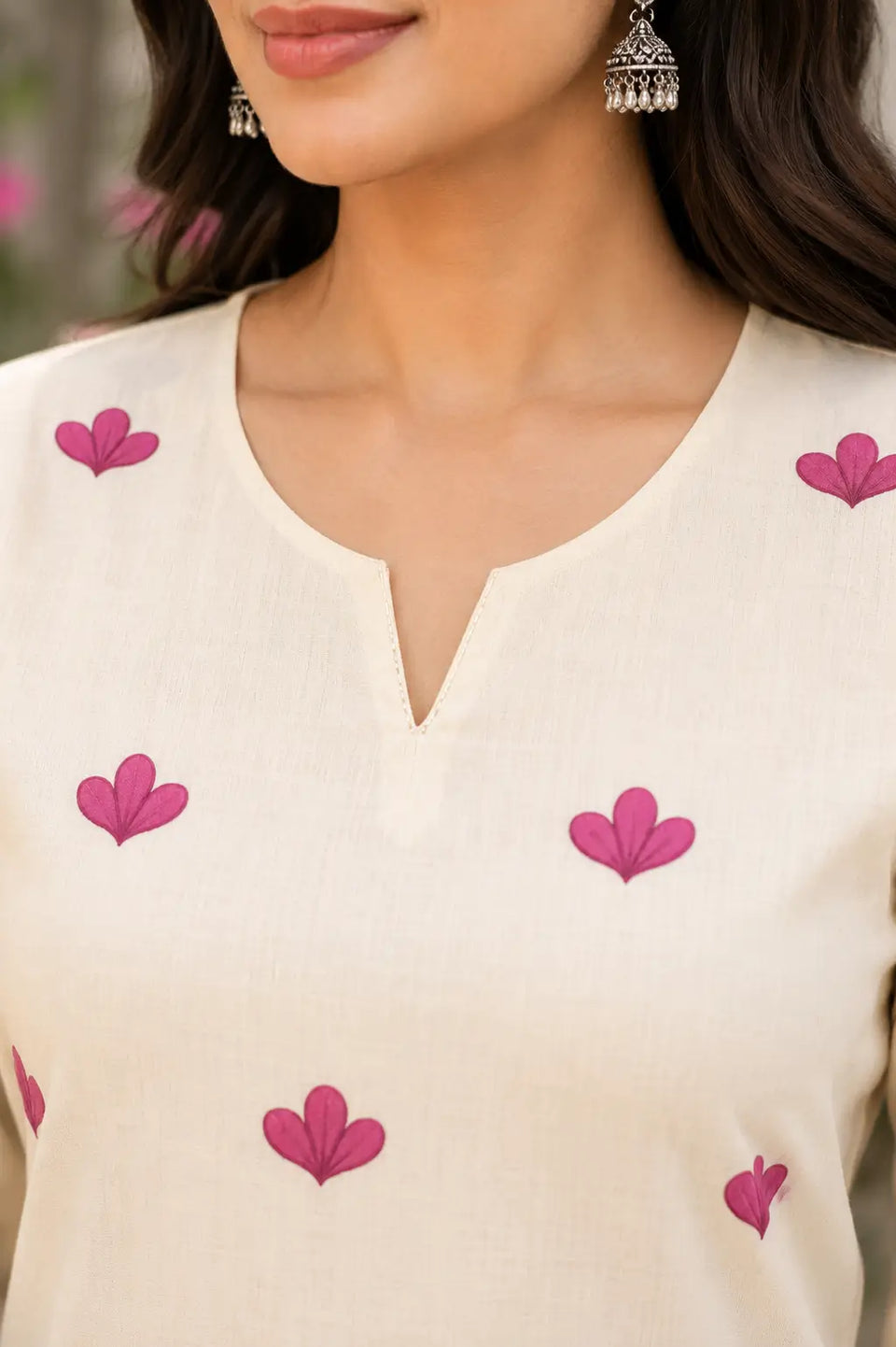 Closeup of stylish neck design on Rabric cream cotton floral print kurti for women