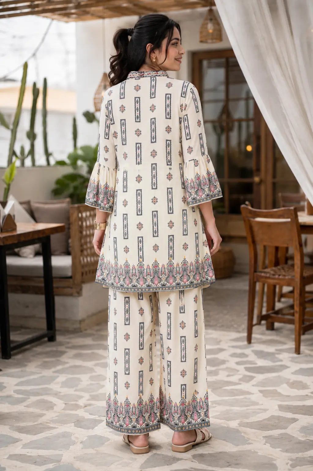 Back view of Rabric cream cotton boho printed co-ord set for women featuring floral border print, 3-4 sleeves and loose palazzo pants ethnic loungewear