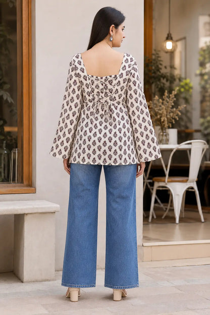 Full back view of Rabric cream cotton floral printed short top with lace up dori design, bell sleeves and hip length style