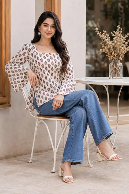 Rabric cream cotton purple floral print short top sitting lifestyle image with stylish denim bottom and full bell sleeves
