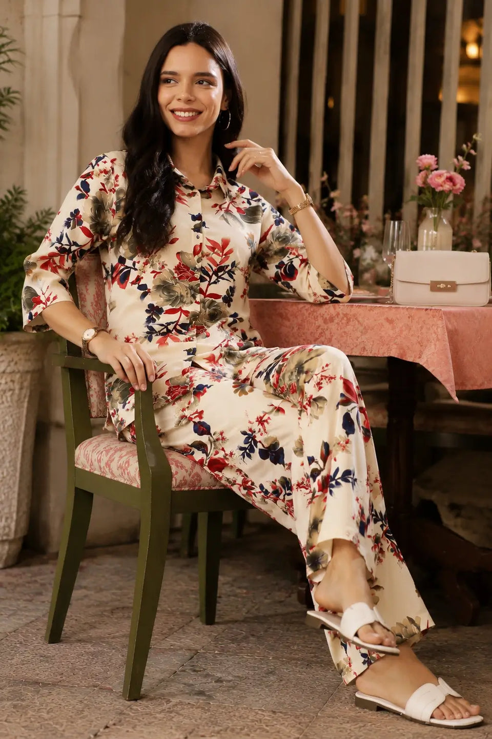 Rabric cream rayon floral print women co-ord set in elegant sitting pose with chic casual accessories