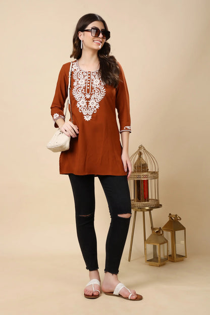 Daily wear crepe short kurti styled with jeans in rust brown colour