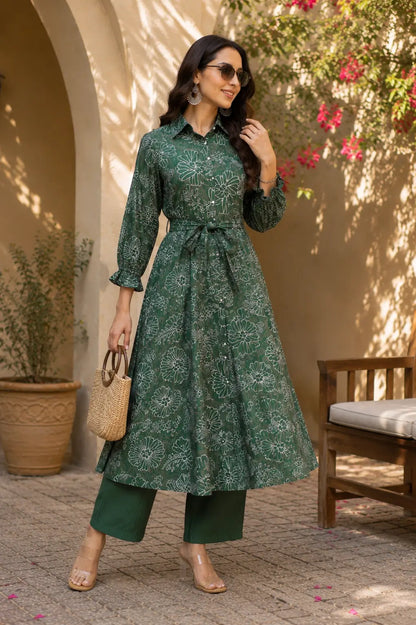 Stylish lifestyle image of Rabric green floral vertical silk kurta palazzo co-ord set with accessories