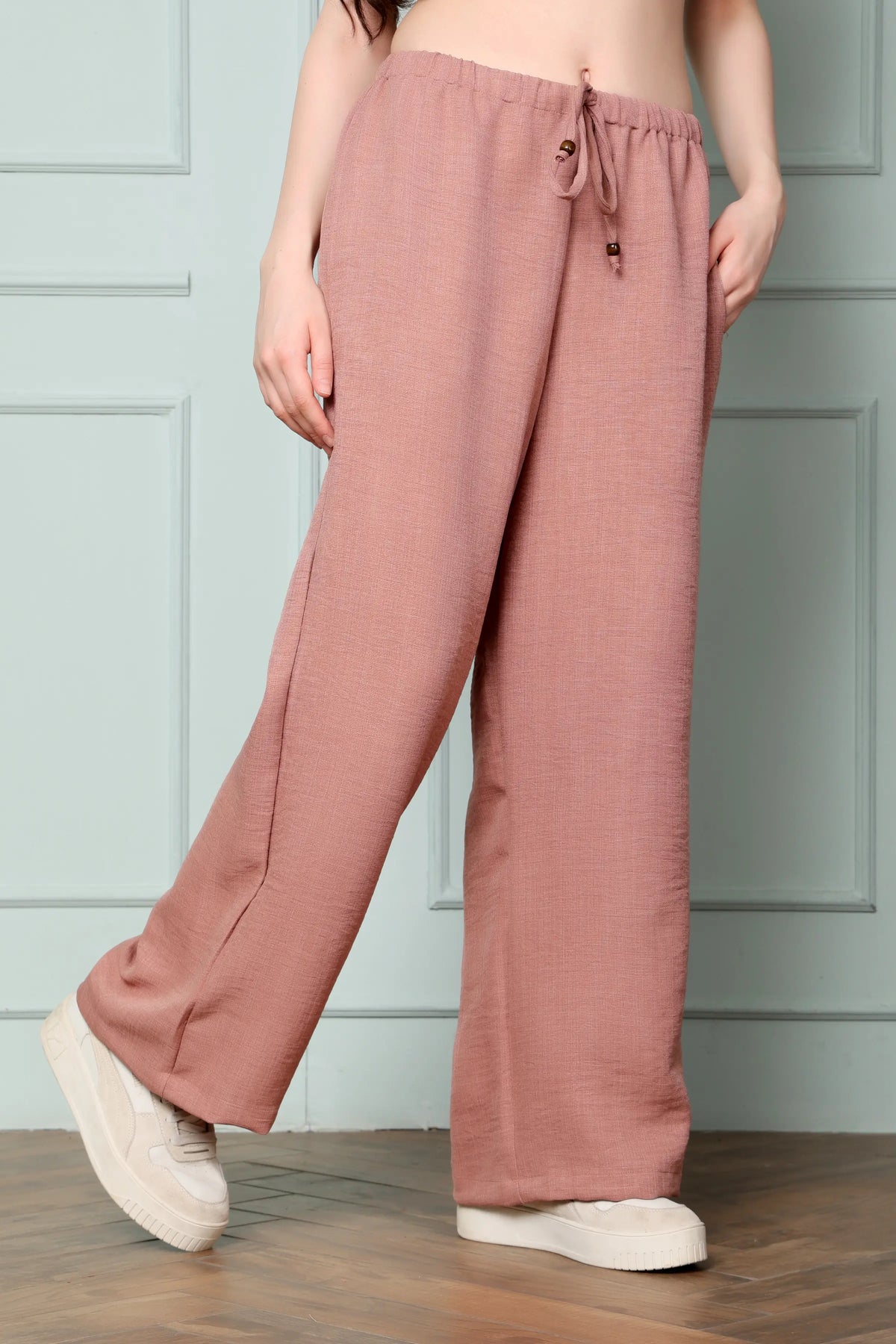 Side view of RABRIC dusty rose linen wide leg pants for women with relaxed fit