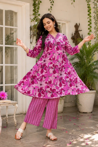 Women twirling in flared pink floral cotton kurta pant set showing beautiful kurta flair and elegant ethnic fashion