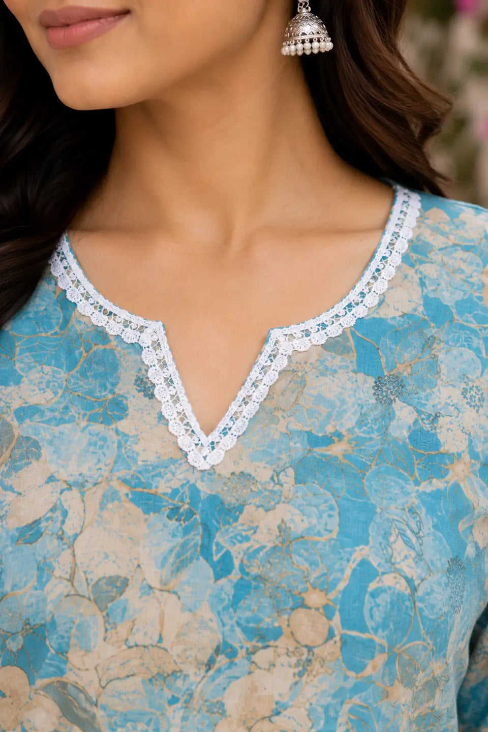 Close up neck design of blue floral cotton short top with white lace detailing for women