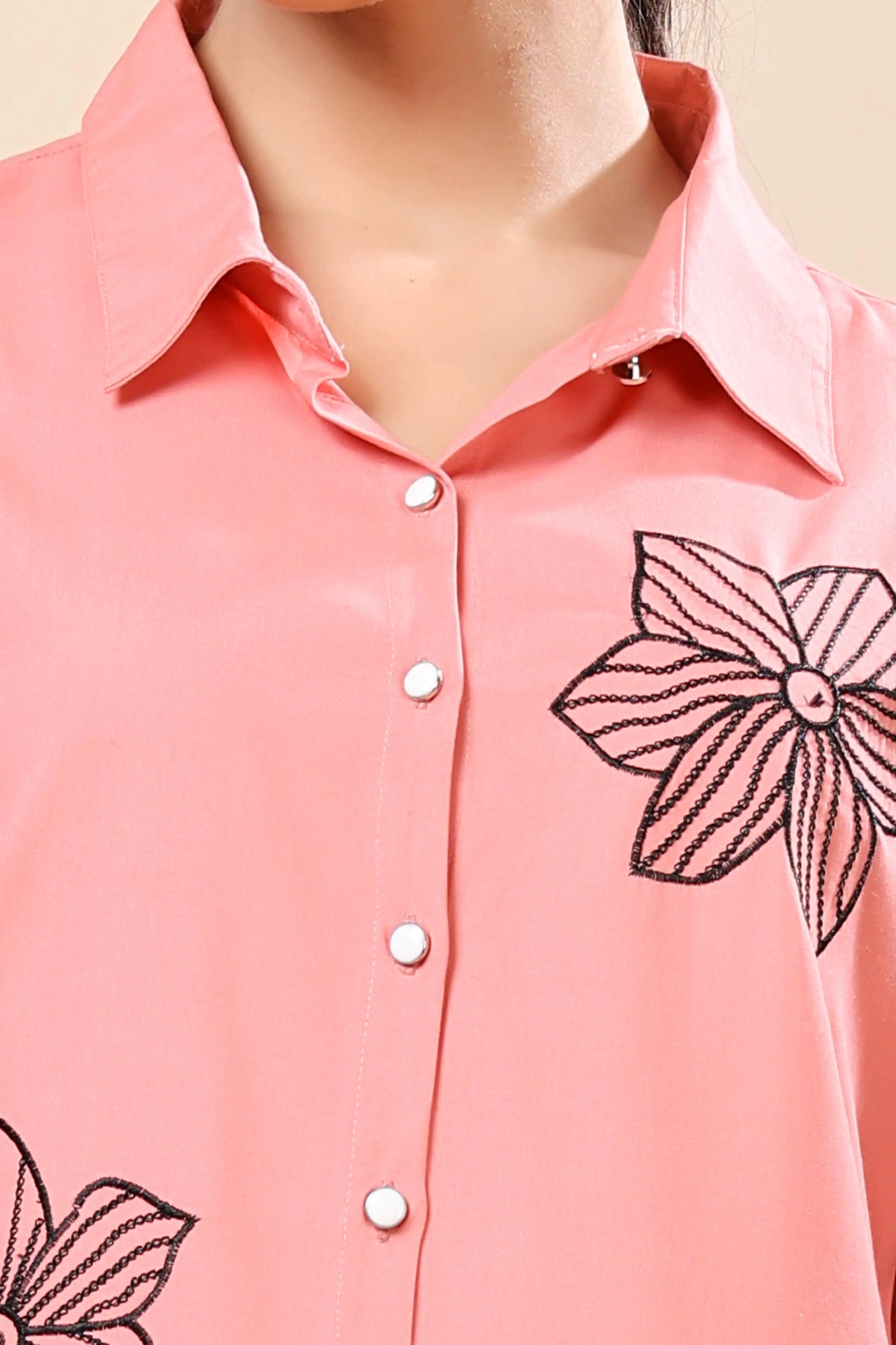 Close-up of floral embroidery design on Rabric peach co-ord set