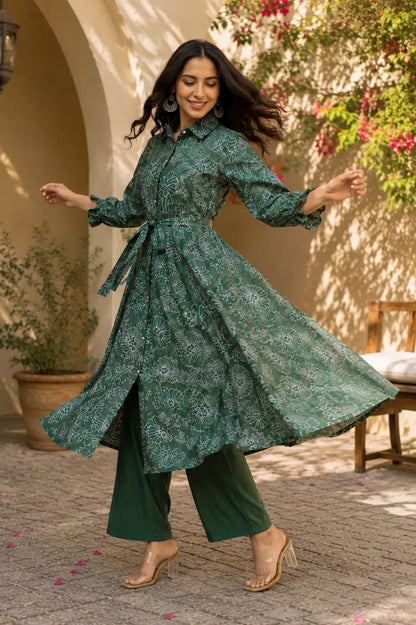 Full flair dancing pose of Rabric green floral long kurta co-ord set in vertical silk fabric