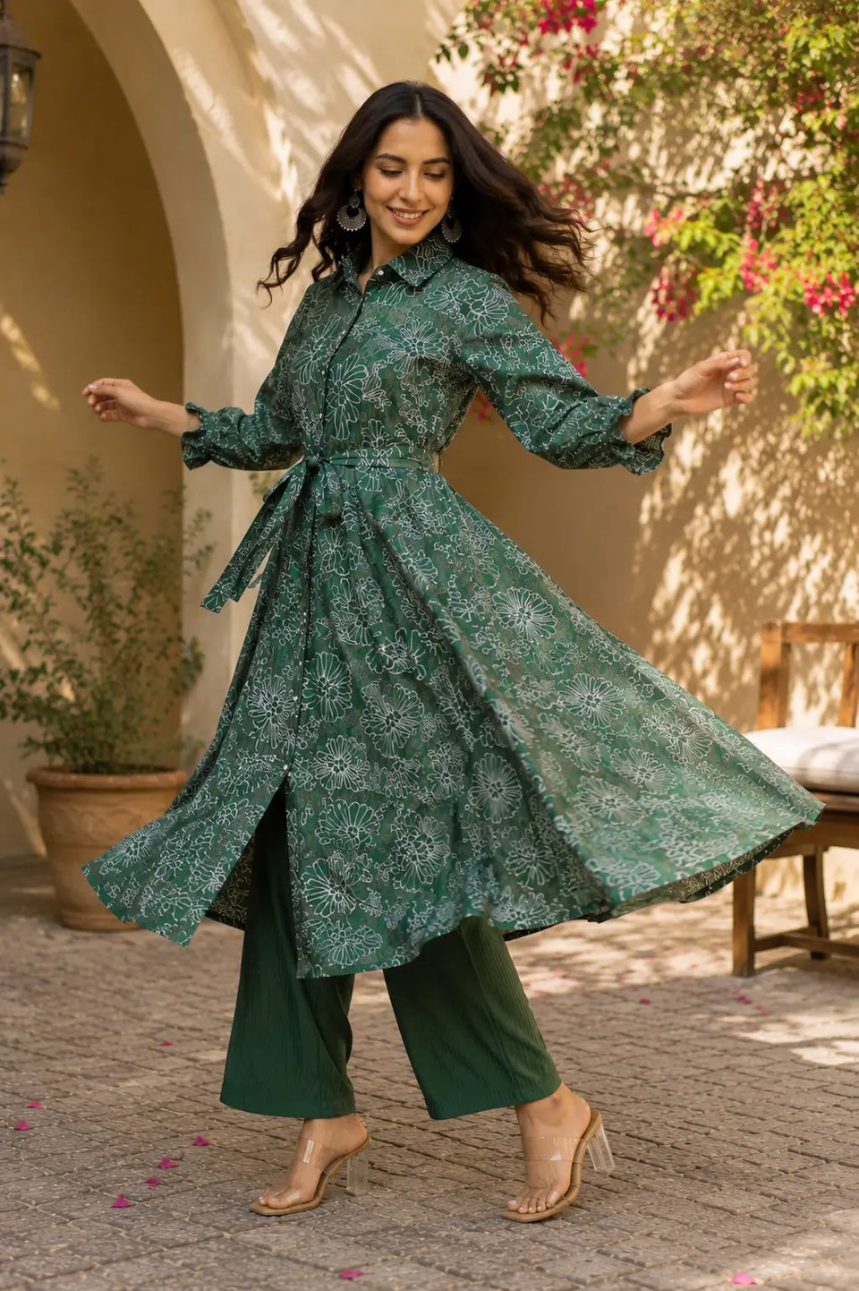 Full flair dancing pose of Rabric green floral long kurta co-ord set in vertical silk fabric