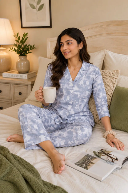Rabric women’s blue glace cotton sleepwear co-ord set in casual sitting pose with cozy bedroom accessories