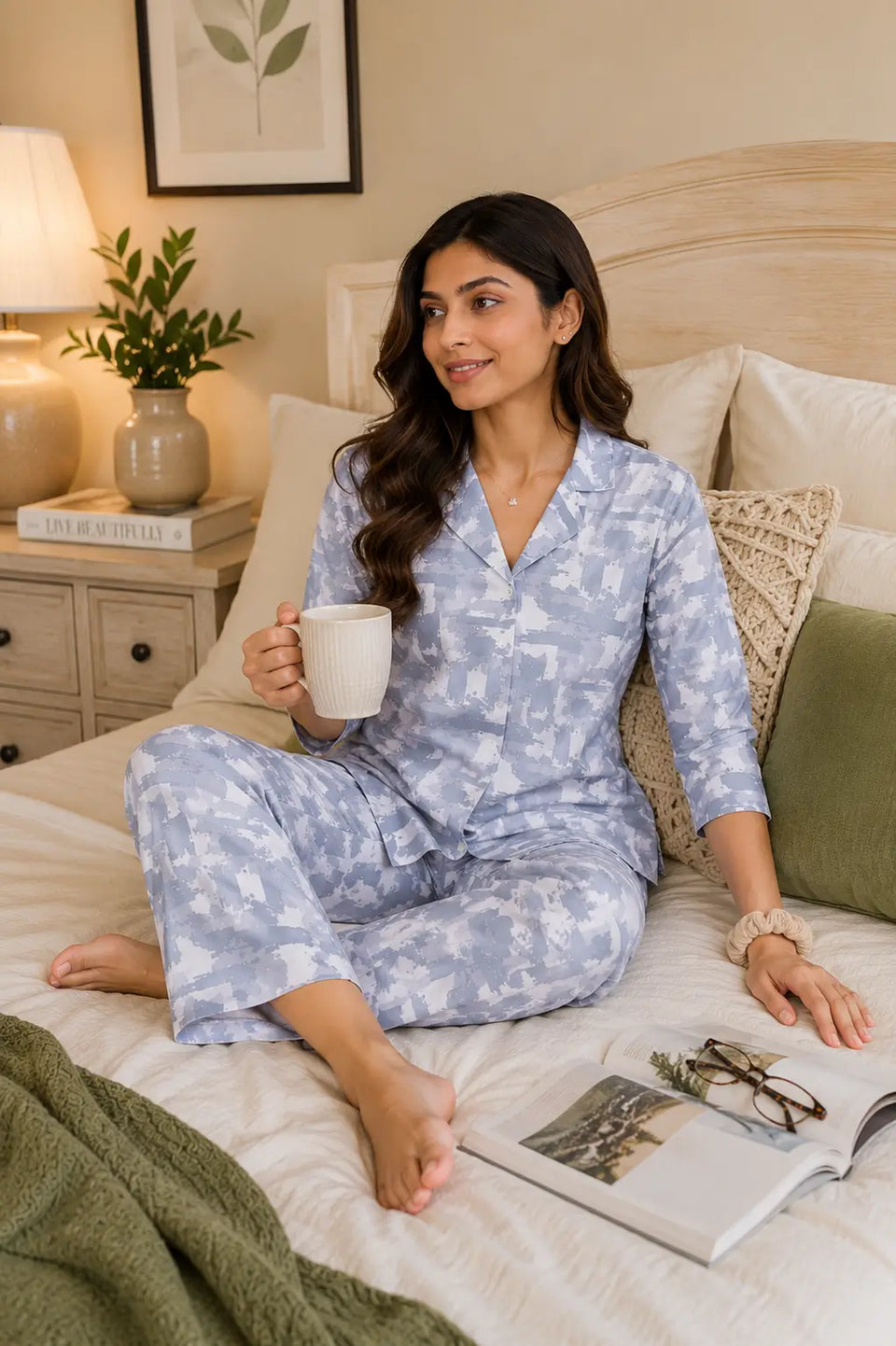 Rabric women’s blue glace cotton sleepwear co-ord set in casual sitting pose with cozy bedroom accessories