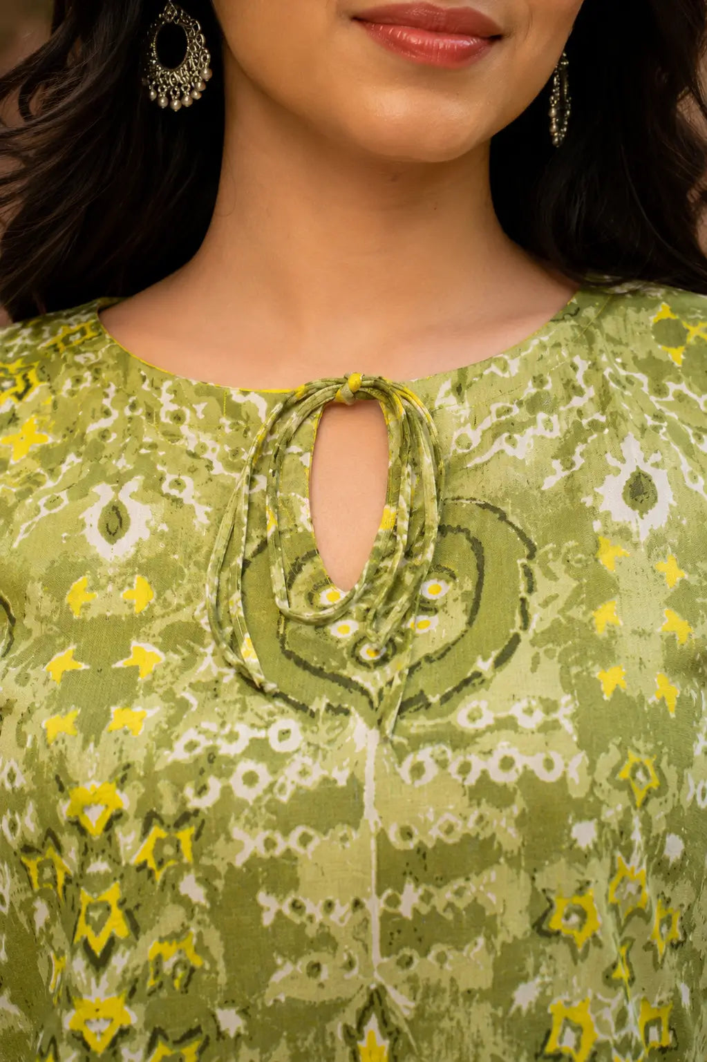 Closeup of RABRIC green printed kurti featuring keyhole neckline and soft fabric