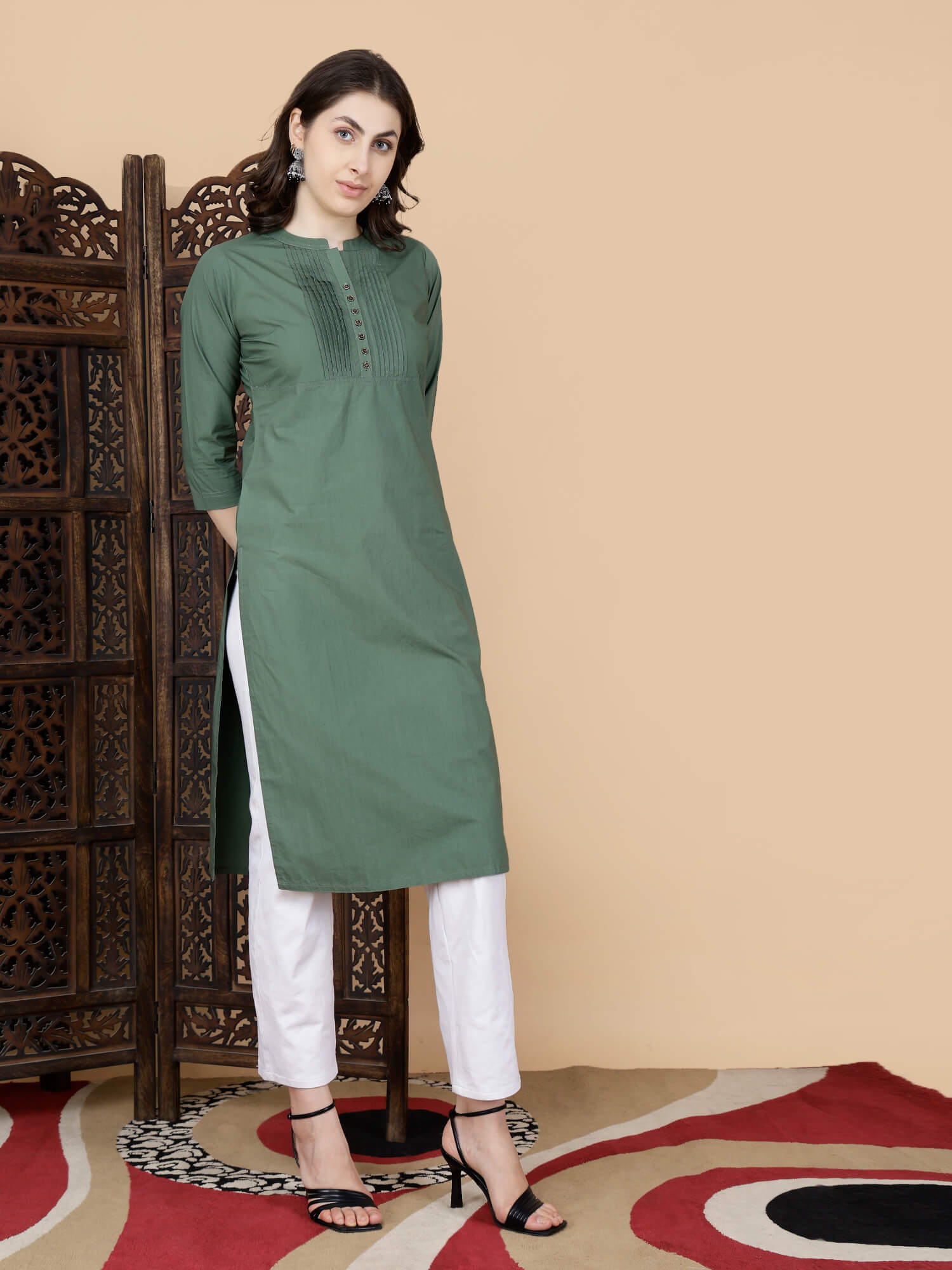 Olive Green Kurti paired with white pants styled by Rabric Stores
