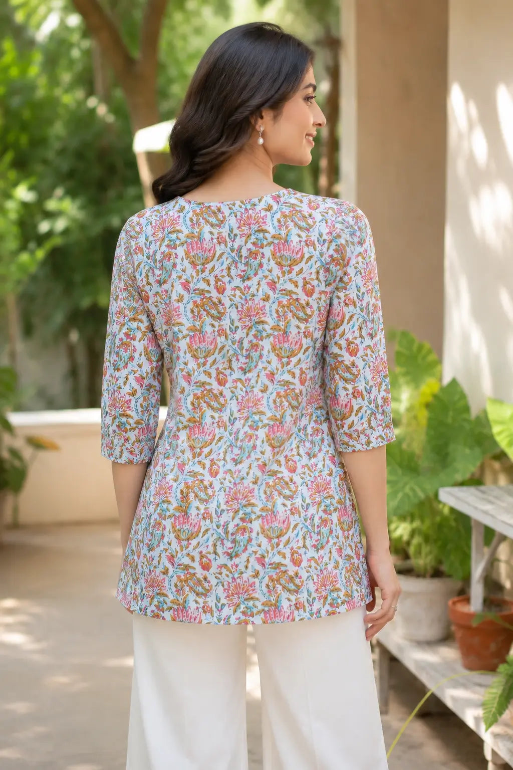 Back view of Rabric light blue floral cambric cotton short top for women with elegant flare and 3/4 sleeves