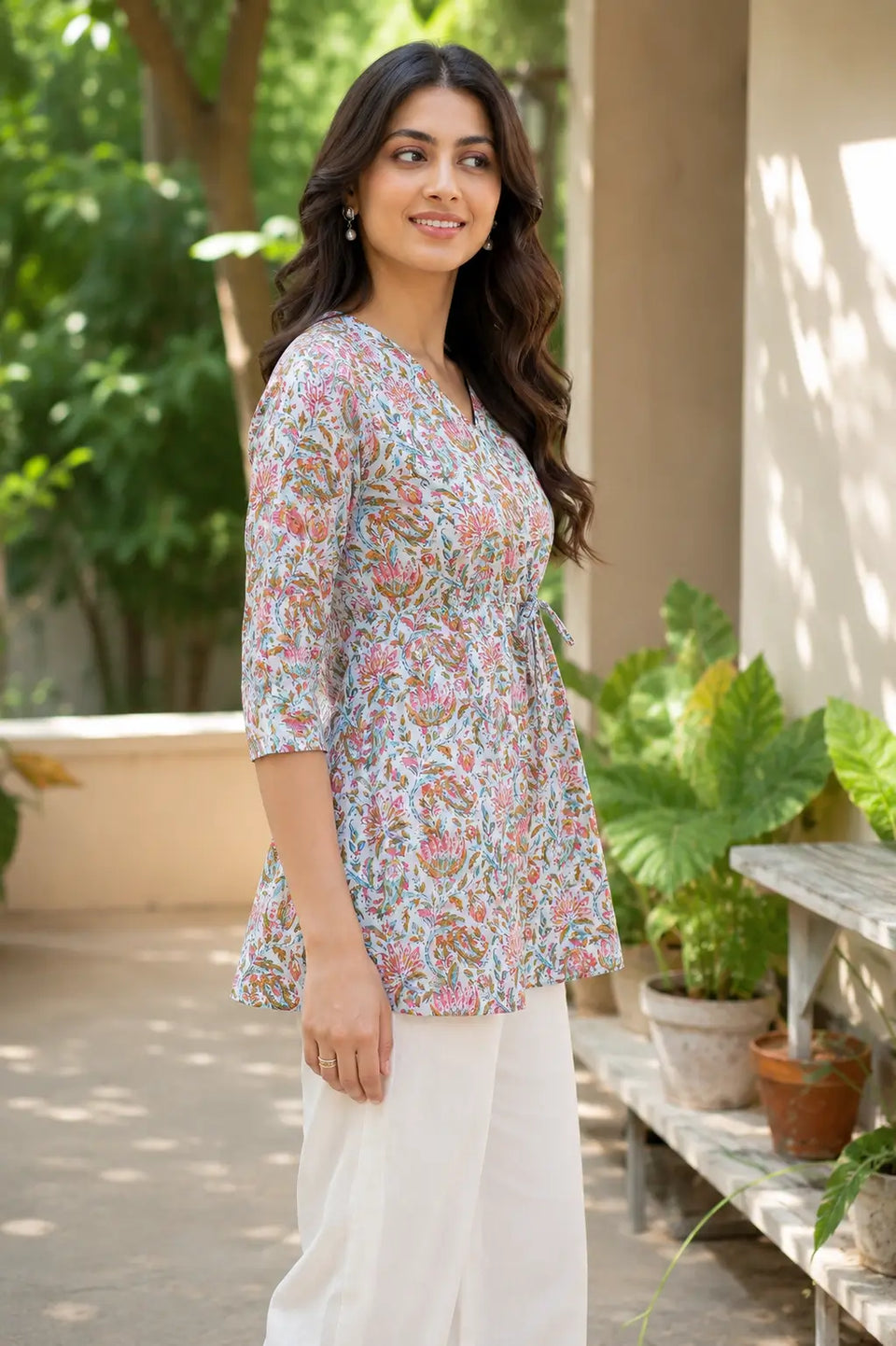 Side angle of Rabric floral cambric cotton short top for women in light blue color with V neck and comfortable flare fit