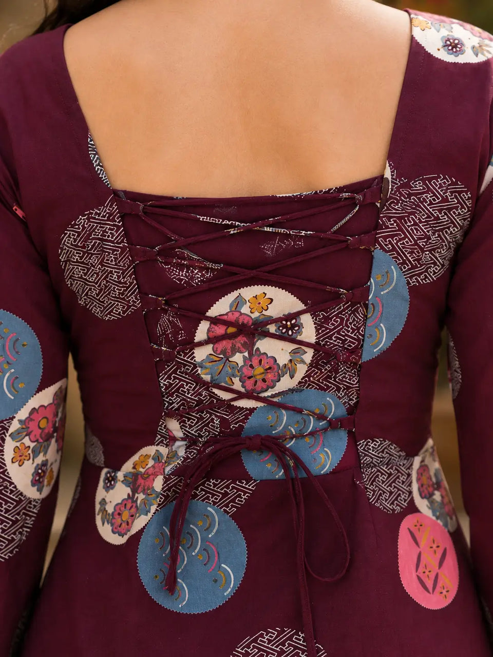 Close up of Rabric maroon cotton short top back dori lace-up design with floral and geometric circular print