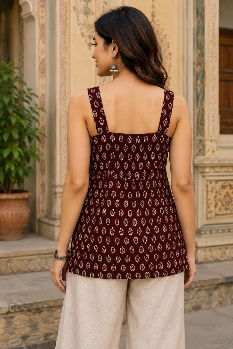 Back view of Rabric maroon pure cotton sleeveless short top featuring ethnic paisley leaf print, comfortable fit and hip length casual wear design