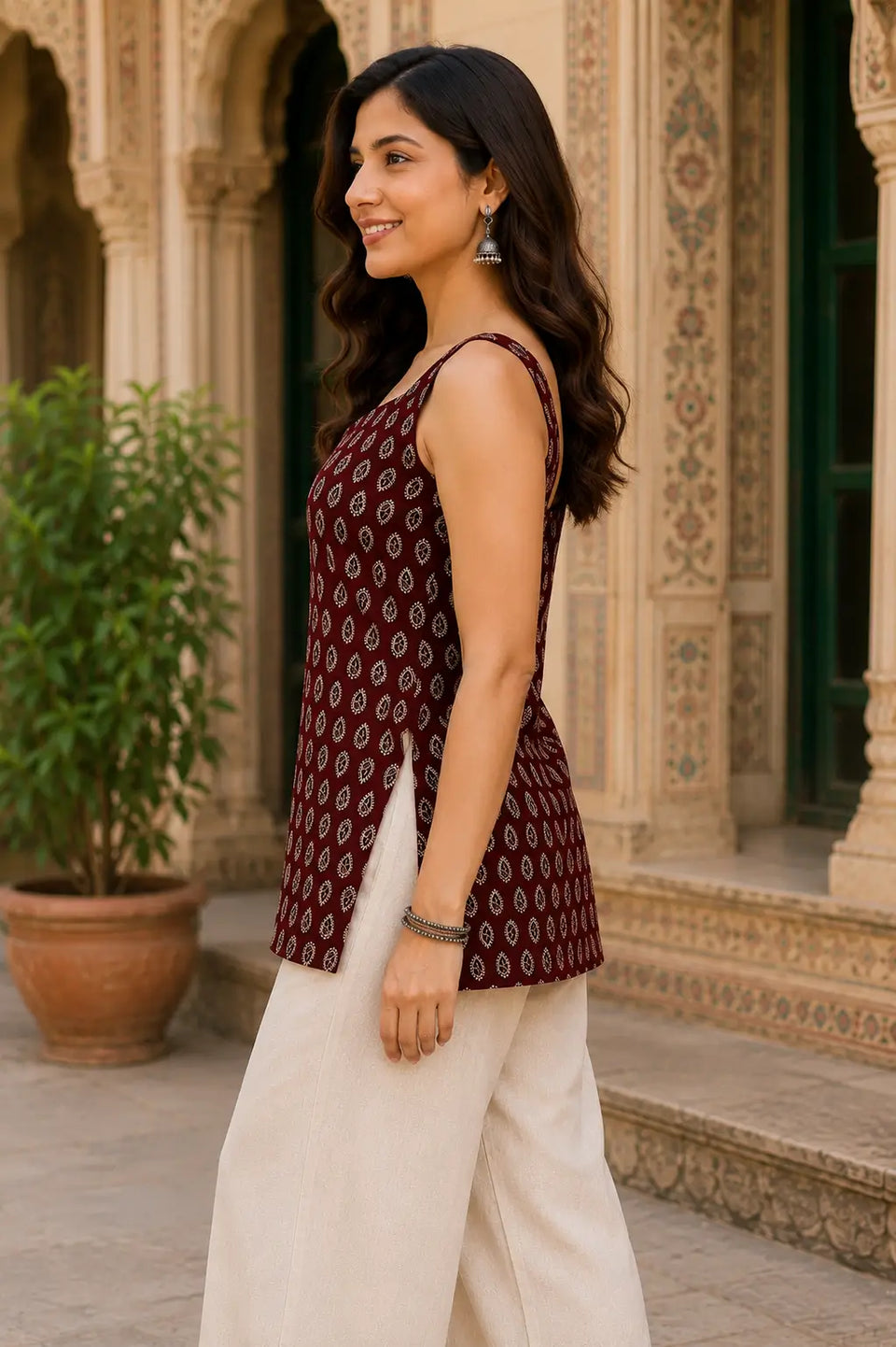 Side view of Rabric maroon pure cotton sleeveless short top for women with ethnic paisley leaf print and relaxed summer wear silhouette
