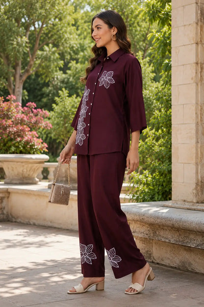 Side view of Rabric maroon rayon co-ord set for women with white flower embroidery on shirt and pant hem