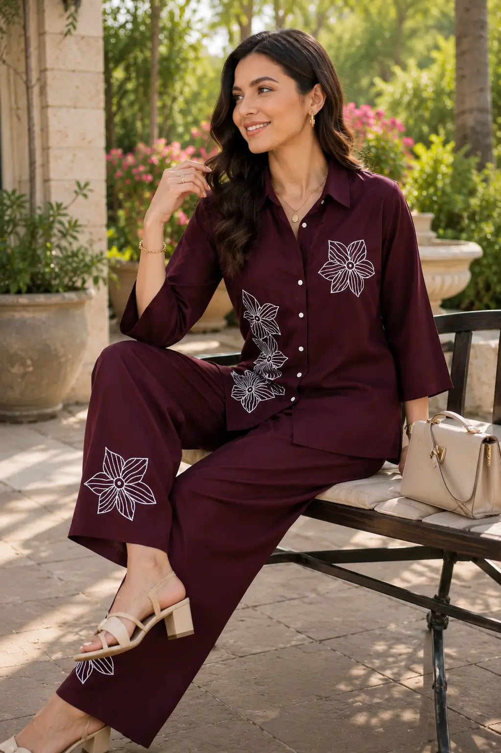 Rabric maroon rayon co-ord set for women in casual sitting pose with accessories, white floral embroidery and relaxed pant fit