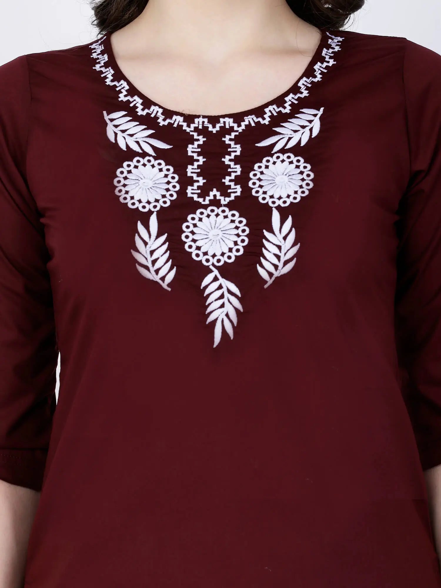 Closeup of White Embroidery on Rabric Maroon Short Kurti Neckline