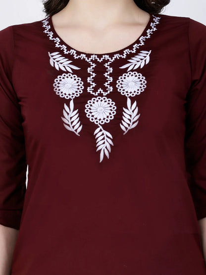 Closeup of White Embroidery on Rabric Maroon Short Kurti Neckline