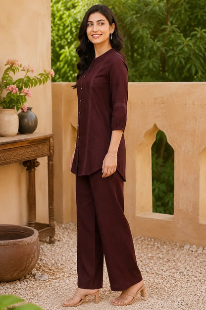 Side profile of Rabric maroon vertican silk co-ord set featuring lace panel detailing, round neck tunic and relaxed fit straight pants.