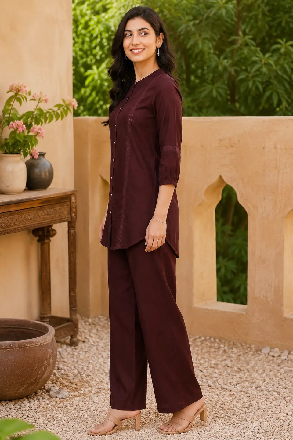 Side profile of Rabric maroon vertican silk co-ord set featuring lace panel detailing, round neck tunic and relaxed fit straight pants.