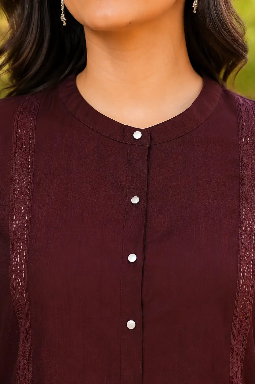 Close-up of round neck and front button detailing on Rabric maroon vertican silk women's co-ord set with premium lace accents.