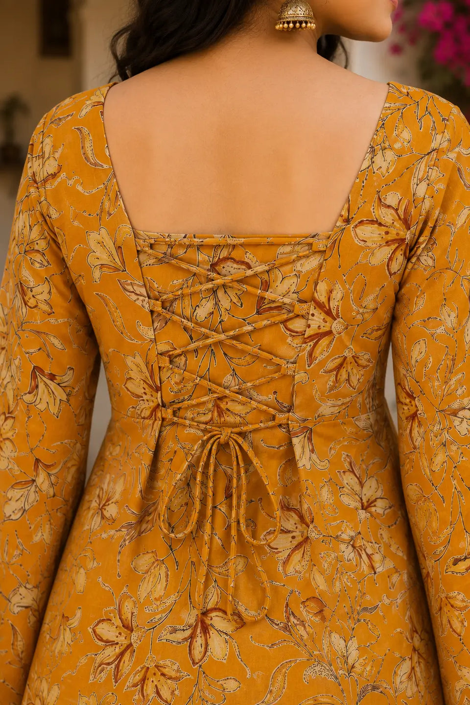 Closeup of back dori lace up design on Rabric mustard yellow cotton floral printed short top for women