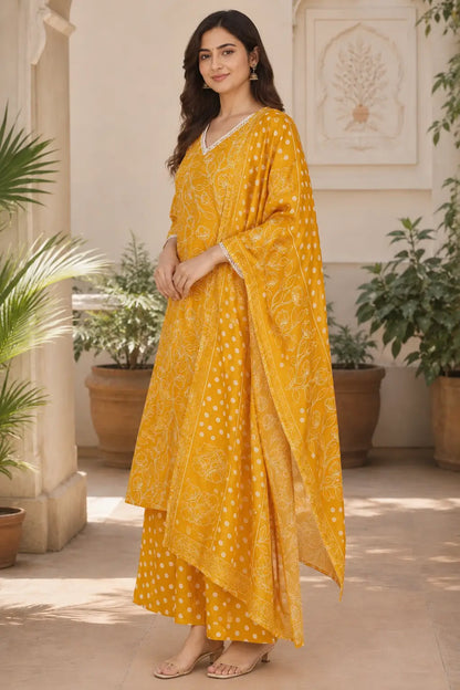 Side view of Rabric mustard yellow cotton floral printed kurta pant set with dupatta featuring 3/4 sleeves, side slit design and comfortable fit.