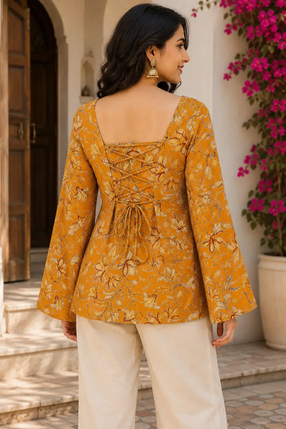 Back view of Rabric mustard yellow cotton floral printed short top with stylish lace up dori design, square neck and full bell sleeves