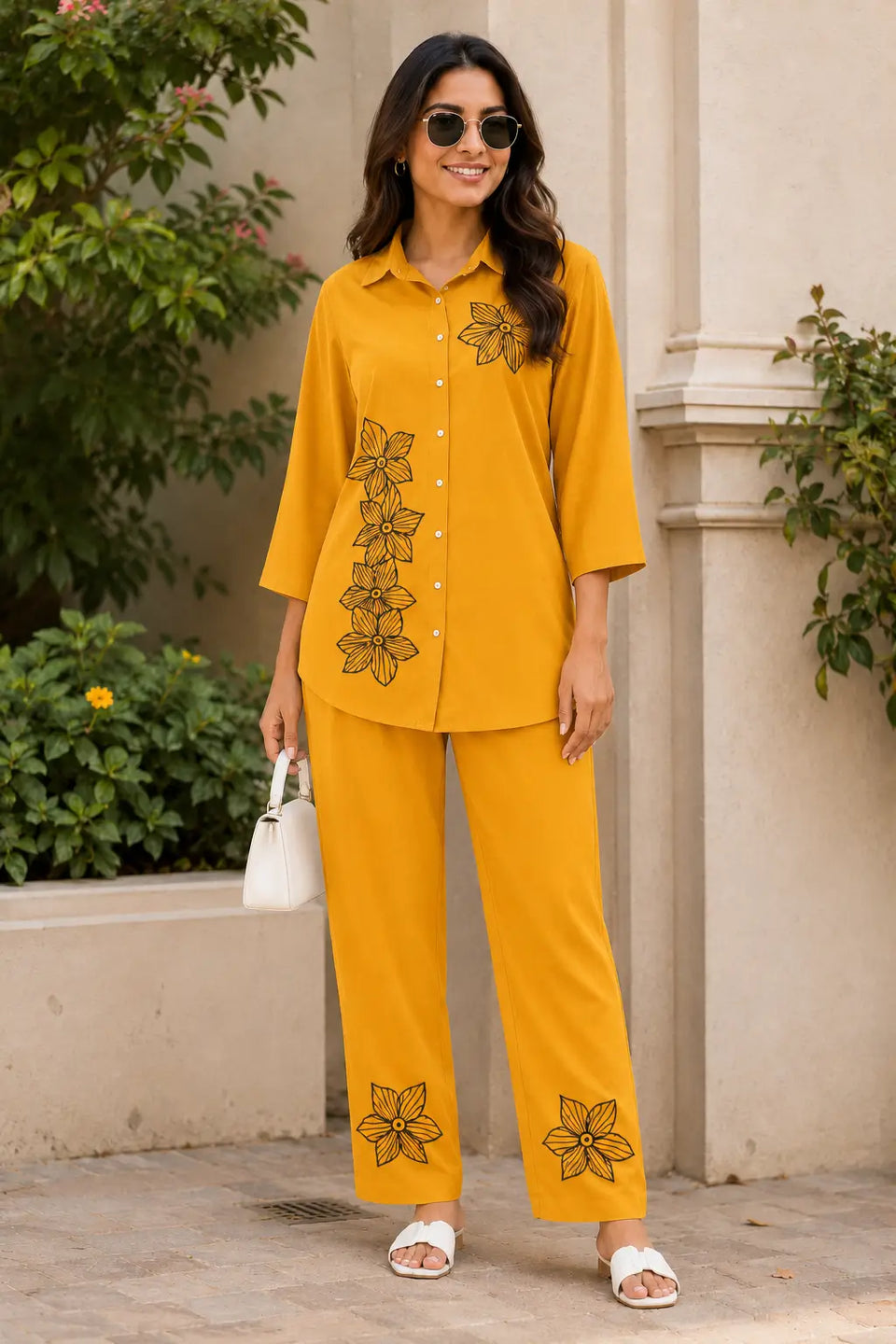 Stylish Indian woman wearing Rabric mustard yellow rayon floral print co-ord set outdoors with relaxed straight pants and collared shirt