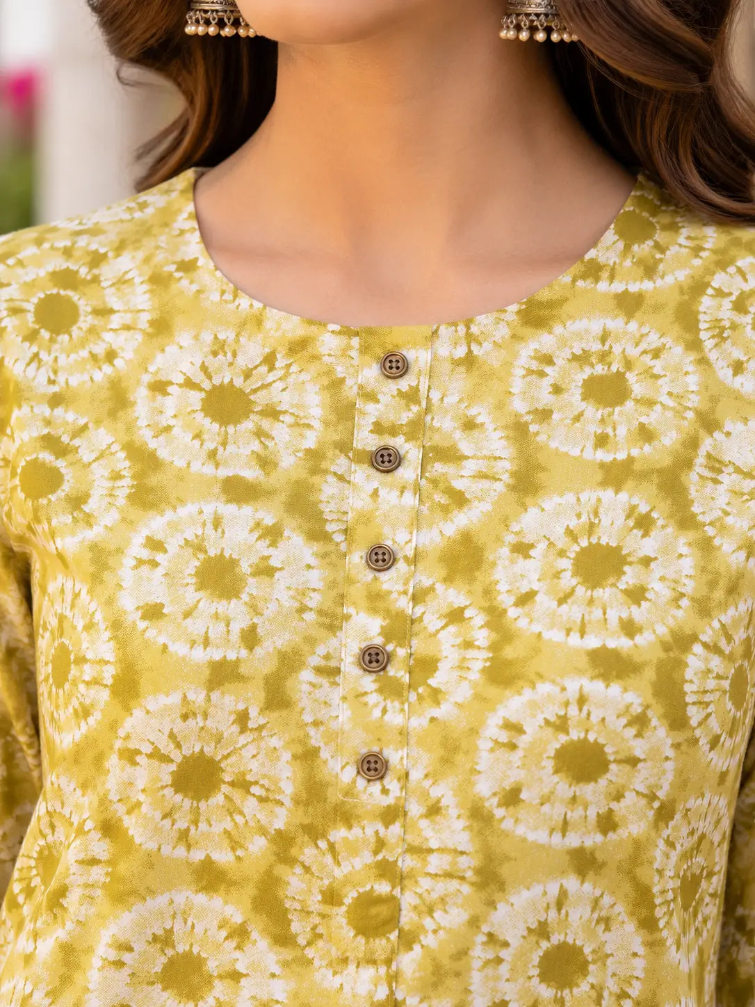 Closeup of round neck button detailing on Rabric mustard yellow rayon printed kurta for women