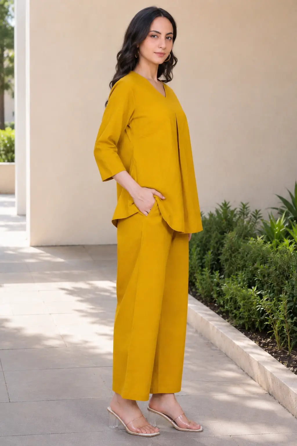 Side view of Rabric mustard yellow solid cotton co-ord set with relaxed short top, wide-leg pajama and single right-side pocket.