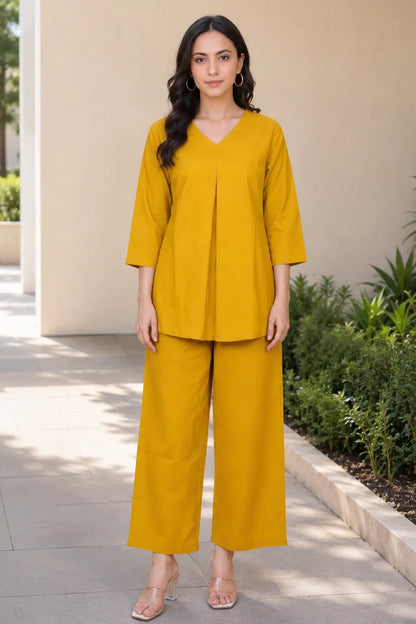 Rabric mustard yellow solid cotton co-ord set for women with V-neck pleated short top and wide-leg pajama, front view.