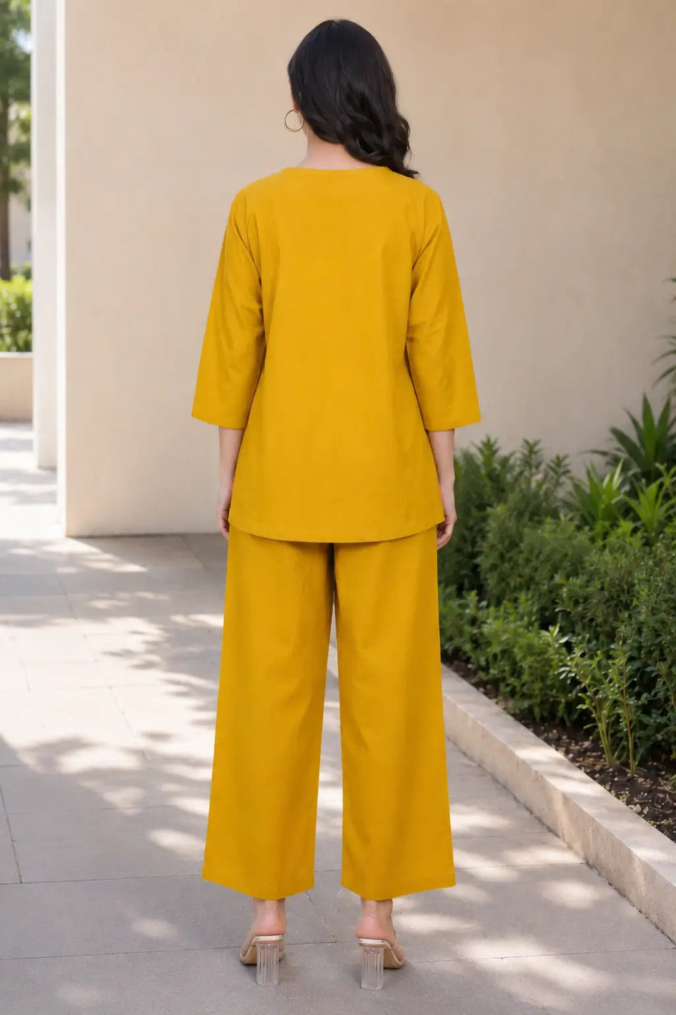 Back view of Rabric mustard yellow solid cotton co-ord set featuring a plain short top with three-quarter sleeves and wide-leg pajama.
