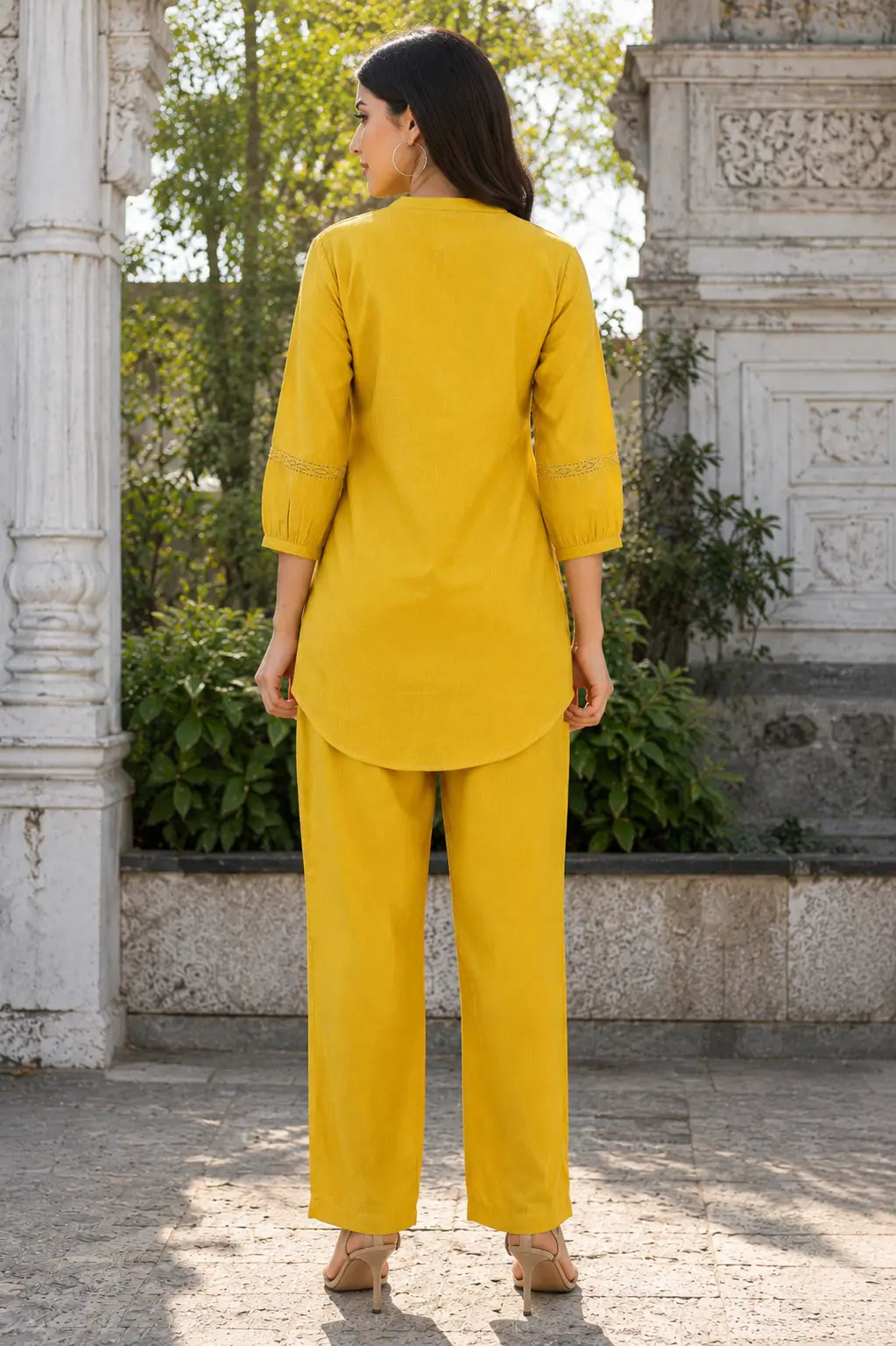 Back view of Rabric mustard yellow Vertican Silk co-ord set for women with clean back design, 3/4 sleeves, relaxed fit shirt and matching straight pants.