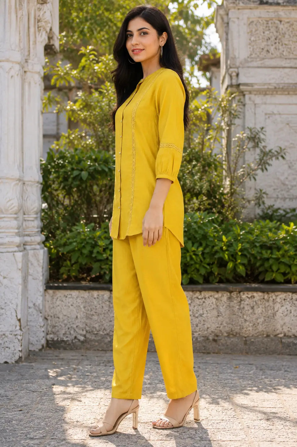 Side view of Rabric mustard yellow Vertican Silk co-ord set featuring a short-length shirt, 3/4 sleeves, lace accents and straight-fit pants.