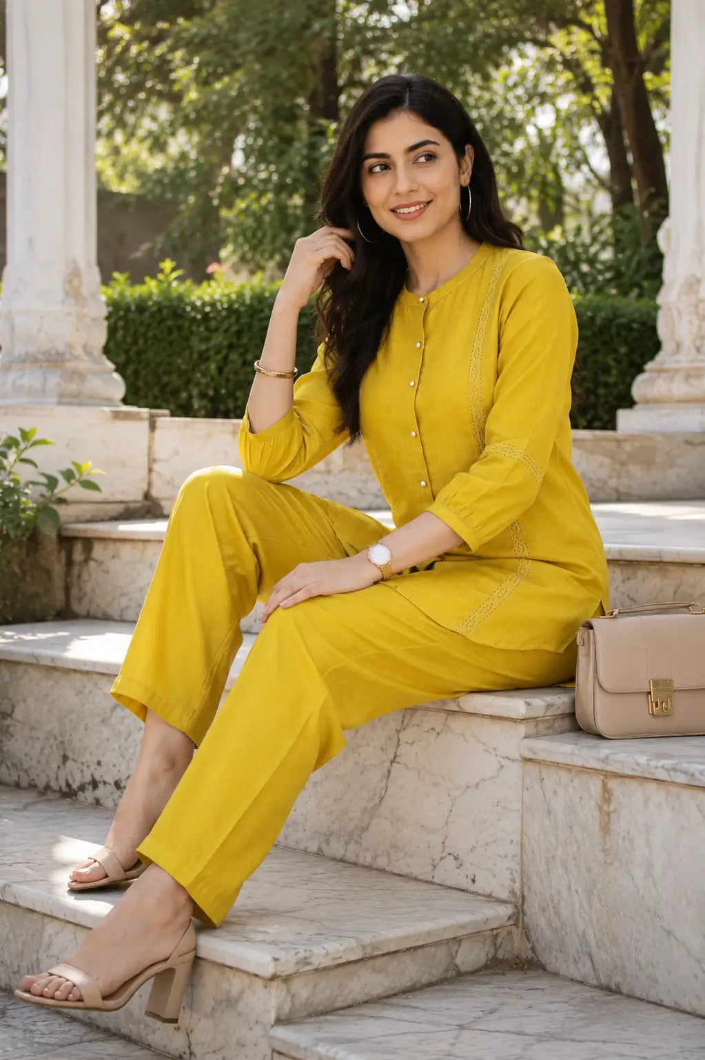 Rabric mustard yellow Vertican Silk co-ord set styled in a casual sitting pose with handbag and accessories, ideal for summer fashion and travel wear.