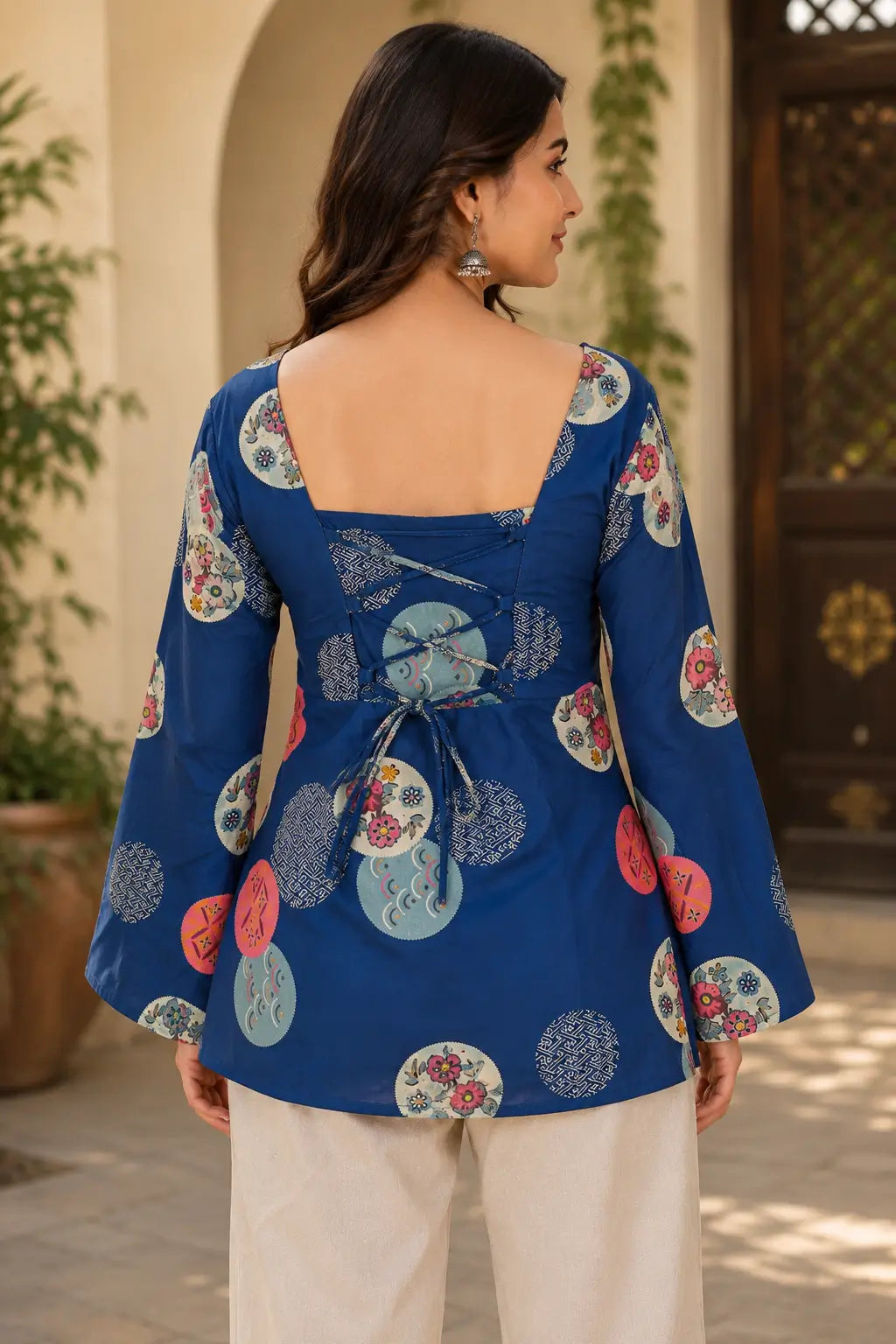 Back view of Rabric navy blue cotton short top featuring adjustable dori lace-up back design, square neck and floral geometric circle print.