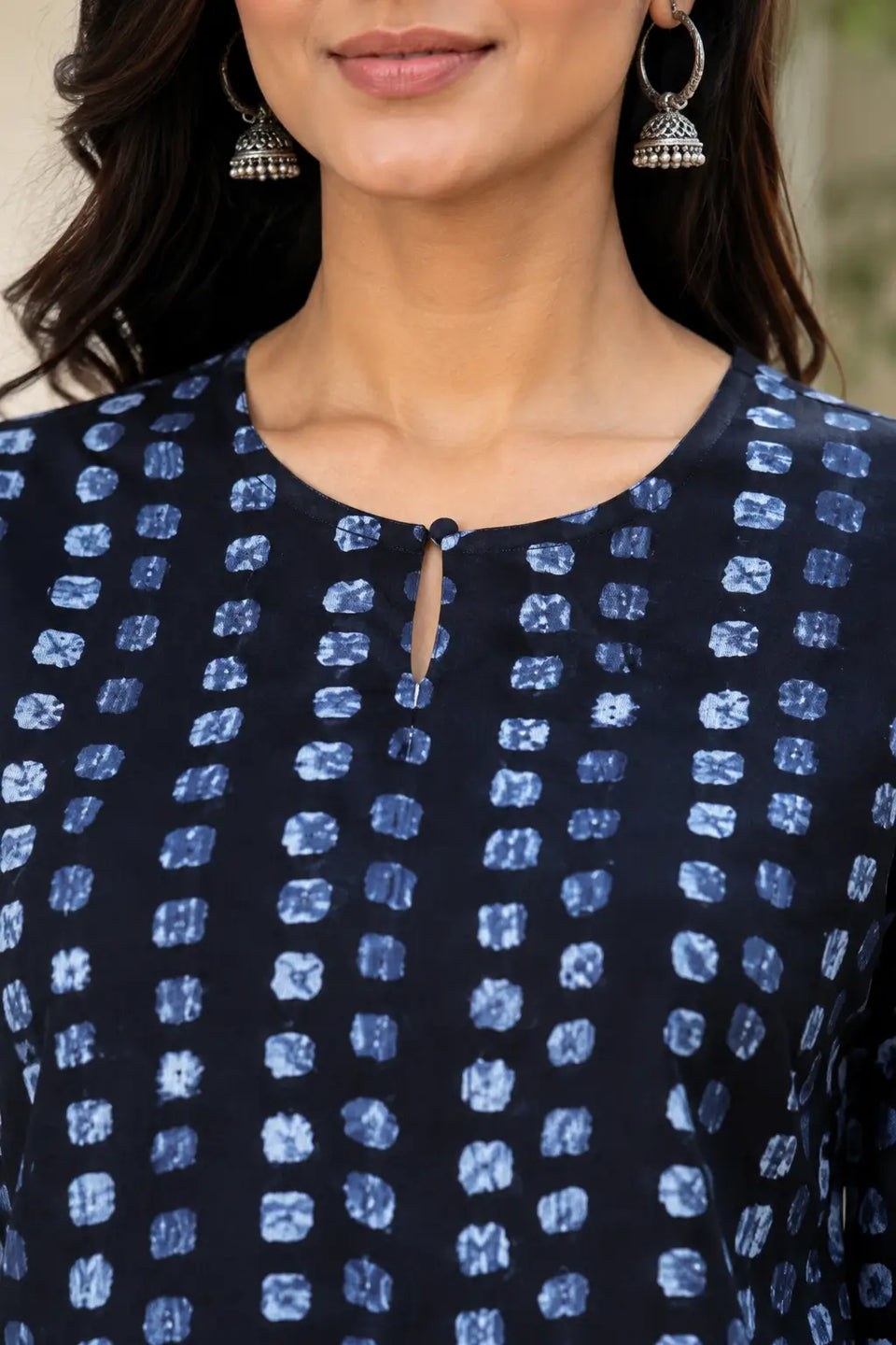 Rabric navy blue cotton printed co-ord set neck close-up showing round keyhole neckline with button detail and light blue abstract dot print
