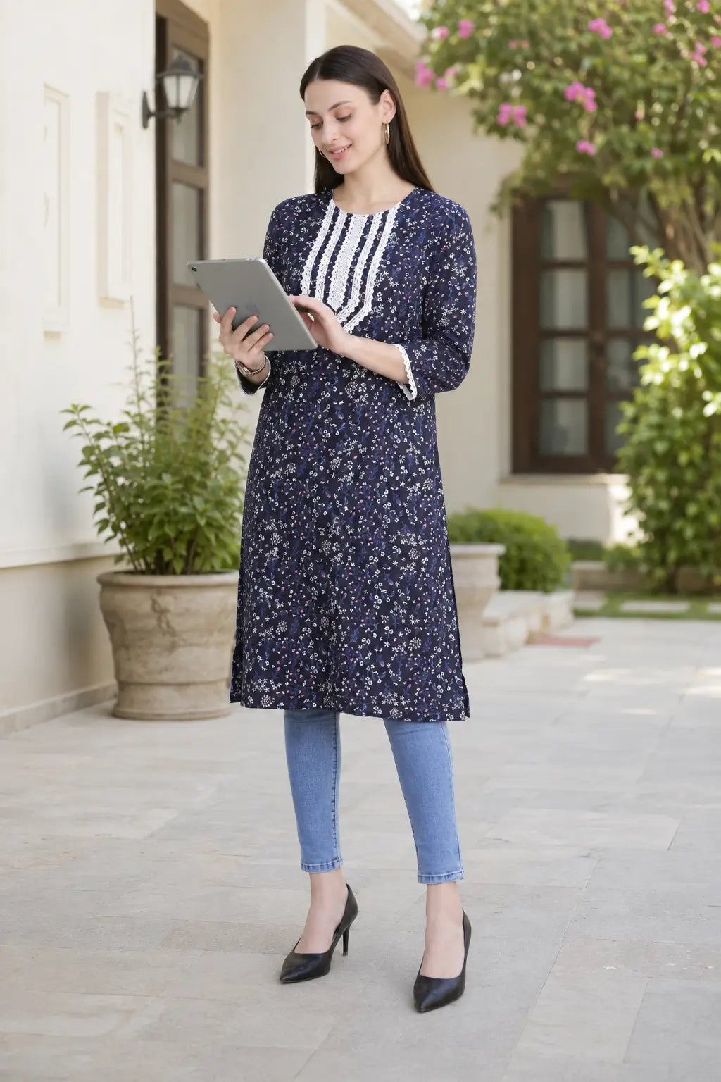 Rabric navy blue cotton floral printed long kurti for women with V-neck embroidered design styled with casual accessories for everyday wear.